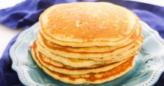 a stack of pancakes sitting on top of a blue plate