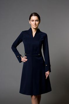 "A beautiful structured dress featuring high neck collar, a-line silhouette, and long sleeves. - high neck (stand collar) - trapeze skirt with inverted front pleat - long sleeves with elegant cuffs - knee length (midi) - a line silhouette - the dress is decorated with high-quality metal buttons Perfect as party, modest bridesmaid or elegant office dress. Seasons: autumn, winter, spring. Color: Blue / Black / Mustard / Burgundy / Grey Fiber: viscose - 60%, elastan - 5%, polyester - 35% Concealed Italian Costume, Stile Casual Chic, Beautiful Cocktail Dresses, Dresses For Wedding Guest, Marine Uniform, Structured Dress, Dark Blue Dress, Long Sleeve Cocktail Dress, Office Dresses For Women