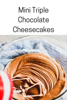 a glass bowl filled with chocolate cheesecakes on top of a blue and white towel