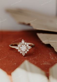 a diamond ring sitting on top of a piece of paper