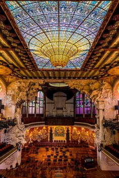 the interior of an old church with stained glass ceiling