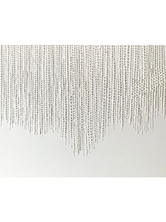 white beads hanging from the side of a wall