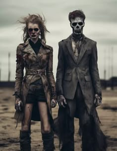 two people dressed up as zombies standing next to each other on dirt ground with cloudy sky in background