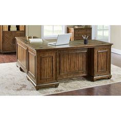 a large wooden desk sitting on top of a hard wood floor