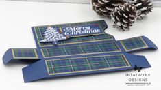 an origami christmas card made with plaid and pine cones