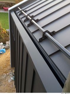 a metal roof that has been installed to the side of a house