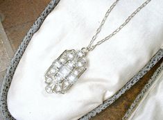 "Offering a stunning vintage Art Deco/Edwardian style pave crystal rhinestone pendant necklace. The geometric open work ornate silver rhodium plated pendant features square and baguette cut as well as round cut brilliantly clear sparkly pave set crystal rhinestones. I love the 1920s design of this one. I've hung the gorgeous pendant from the perfect dainty platinum toned SO Art Deco chain that fastens with a ring clasp. I've added an extra ring to the chain for versatility in length worn. It can Art Deco Diamond White Necklace For Wedding, Diamond White Art Deco Necklace For Wedding, Vintage Diamond White Necklace For Wedding, 1920s Design, Vintage Wedding Jewelry, Vintage Rhinestone Jewelry, Edwardian Style, Edwardian Fashion, Wedding Necklaces