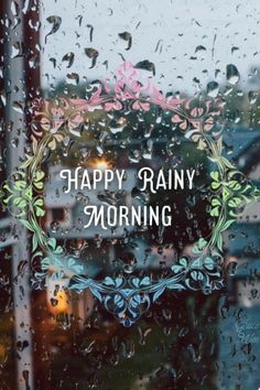 the words happy rainy morning are displayed through a window