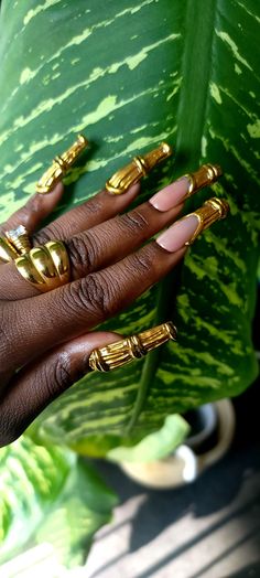 Your inner ghetto girl and 90s child dreams are realized. This iconic nail set draws inspiration from the timeless bamboo hoop earrings. Each design features intricate gold detailing that mimics the look of real, welded gold, adding a touch of sophistication and craftsmanship. The combination of classic shapes and modern detailing creates a bold, stylish look that seamlessly blends tradition with contemporary flair. Ideal for those who appreciate unique, fashion-forward accessories, this set bri Kente Cloth Nail Art, Funky Brown Nails, Jewelry Nails Design, Simple Freestyle Nails, Afrocentric Nails, All Gold Nails, Guitarist Nails, Green And Gold Nails Acrylic, Lipstick Shaped Nails