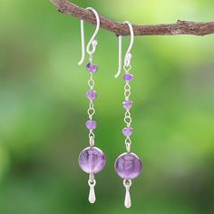 Matta in Thailand uses smooth purple gems to hand craft her lovely pair of dangle earrings. The artisan begins with a large amethyst orb which swings from a column of faceted amethyst gems. A silver-plated brass bead dangles below the orb while sterling silver hooks accents add shine and opulence. Chain Earrings Dangle Diy, Dangly Purple Earrings, Purple Wire Wrapped Long Drop Jewelry, Lavender Amethyst Dangle Earrings, Handmade Amethyst Long Drop Jewelry, Handmade Long Drop Amethyst Jewelry, Purple Long Drop Jewelry With Ear Wire, Nickel Free Amethyst Long Drop Earrings, Amethyst Long Drop Earrings For Pierced Ears