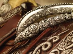 an intricately decorated leather saddle with silver accents