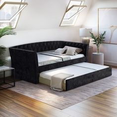 a bed that is in the middle of a room with some pillows on top of it