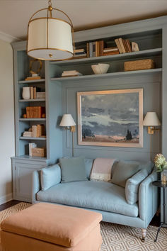 a living room filled with furniture and a painting on the wall above it's bookshelf