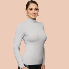 Indulge in the opulent coziness and effortless elegance of our newly updated mock neck. Featuring a sleek and refined neckline, it now comes in 10 stunning hues. Crafted from luxurious Italian 4 way stretch microfiber fabric, it delicately cascades over the figure and eliminates clinginess when layered with other garments. An essential piece for your autumn and winter collection, this top can be worn alone for a striking look or layered under sweaters or jackets.