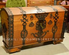 an old wooden trunk sitting on top of a tile floor