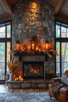 a living room with a stone fireplace and lots of candles