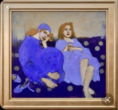 two women are sitting on a couch with polka dotes in the background and one is wearing a blue dress