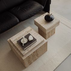 two square tables sitting on top of a white rug