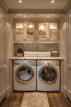 a washer and dryer in a small room with wood flooring on the side