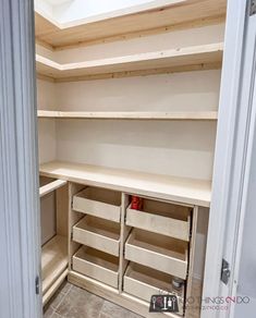 an empty closet with shelves and drawers