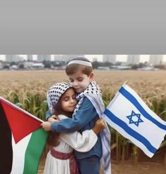 two children hugging each other in front of a flag and cornfield with buildings in the background