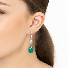 Steal the spotlight with the Zara Teardrop Colombian Emerald Gemstone Earrings in Silver. These stunning pieces boast a captivating pear-shaped lab-created emerald set in a beautifully detailed silver frame, highlighted by a row of three marquis-shaped simulated diamonds for an extra dash of elegance.  Emeralds, known for their rich green hue, are not just May's birthstone but also symbols of rebirth, love, and wisdom. Whether you're dressing to impress at a gala or adding a sophisticated touch Elegant Gemstone Teardrop Chandelier Earrings, Gemstone Teardrop Earrings For Wedding, Wedding Gemstone Teardrop Earrings, Wedding Teardrop Gemstone Earrings, Teardrop Gemstone Bridal Earrings For Formal Occasions, Formal Teardrop Gemstone Bridal Earrings, Teardrop Jewelry With Gemstone Accents For Evening, Teardrop Gemstone Accents Jewelry For Evening, Evening Teardrop Gemstone Accented Jewelry