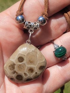 Handpolished Florescent PETOSKEY STONE NECKLACE paired with an Adjustable MALACHITE & QUARTZ Ring plus I always include extra goodies ♥️  I handpolished this PETOSKEY stone specimen to a satin shine ✨️ 😎 🥰 it is a beautiful light cream with brown corralite centers and bold corralite borders and septa lines .there is even a sorta heart shaped corralite 😍🥰  and I paired it with a stunning ADJUSTABLE MALACHITE RING this one is cut so it has gorgeous straight bands in so many shades of green  And it has faceted quartz crystals , one on each side .❤️️ I always include extra goodies starting with WATERLEVEL BANDED CARNEILAN TUMBLE , ,I always love to include a PETOSKEY STONE SPECIMEN and some other coral fossils and minerals from Lake Michigan (self collected) these fossils are even WAYY old Adjustable Jewelry With Large Stone For Gift, Nickel-free Round Earthy Jewelry, Nickel-free Earthy Round Jewelry, Adjustable Nature-inspired Jewelry With Stones, Brown Jewelry With Natural Stones As Gift, Handmade Spiritual Rectangular Jewelry, Brown Natural Stone Jewelry As A Gift, Unique Brown Jewelry For Everyday, Nickel Free Earthy Silver Jewelry