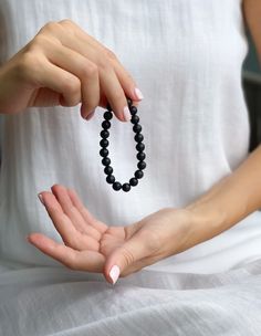 This obsidian beaded bracelet is the perfect way to add a touch of natural magic to your look. The black beads are said to contain powerful healing energy and are thought to bring good luck and protection against negative forces.

This Black obsidian bracelet is the perfect way to access the power of the universe. Made with natural obsidian stones, this bracelet is a powerful tool for better health, peace of mind, and spiritual growth. Obsidian Round Beads Bracelet For Meditation, Obsidian Round Beads Bracelets For Meditation, Obsidian Beaded Bracelets With 8mm Beads As Gift, Spiritual Obsidian Round Beads Bracelet, Spiritual Obsidian Bracelet With Round Beads, Spiritual Obsidian Bracelets For Healing, Obsidian Beaded Bracelets For Healing, Elegant Obsidian Bracelets For Meditation, Spiritual Obsidian Beaded Bracelets