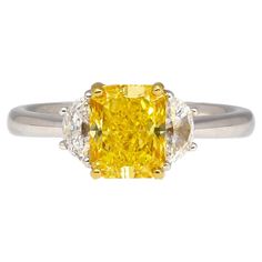 Prepare to be mesmerized by the extraordinary beauty of this three stone engagement ring, featuring a GIA certified 2.01 carat fancy vivid yellow radiant cut diamond center stone. Flanked by two half-moon cut F color diamond side stones. Set in 18K white and yellow gold. The center stone is eye-clean and full of life. Its natural color is on full display with an open back behind the culet. Item Details: - Type: Engagement Ring - Metal: 18K Yellow and White Gold - Weight: 4.06 Grams - Setting: Th Elongated Radiant, Wedding Watches, Rare Colors, Diamond Three Stone Ring, Three Stone Engagement Ring, 3 Stone Rings, Radiant Cut Diamond, Three Stone Ring, Three Stone Engagement