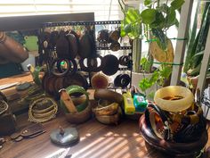 a wooden table topped with lots of different types of jewelry