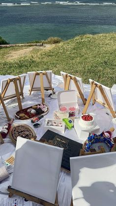 there are many items on the table with water in the backgroung behind them