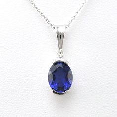 Lab grown sapphire 7x9mm oval cut gemstone is set in a sterling silver pendant setting with a rhodium finish. Rhodium protects the silver from oxidizing quickly as well as gives the appearance of white gold. Cubic zirconia accent enhances the pendant design on the top of the design. Pendant comes on an 18 inch long cable chain. Style Number: 19568 Metal: 925 Sterling Silver Gemstone: Lab Grown Sapphire Dimensions: 13/16 inch long and 1/4 inch wide, 18 inch chain Oval Sapphire Necklace With Hallmark, Oval Sapphire Necklace With Brilliant Cut, Sapphire Jewelry With Brilliant Cut Oval Pendant, Silver Sapphire Oval Pendant Jewelry, Silver Sapphire Oval Necklace, Silver Oval Sapphire Necklace, Brilliant Cut Sapphire Oval Pendant, Oval Sapphire Silver Necklace, Oval Sapphire Necklace With Polished Finish