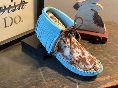 These handmade moccasins will not disappoint.  A vibrant aqua hued suede accented with a speckled cow print hair on toe.  Unique, stylish, you. Made completely of leather and lined with an additional insole of leather.  This configuration is ideal for earthing/grounding.  This may be substituted with a synthetic sherpa type pad inside at no cost. Look around the site, our imagination is all that limits us in coming up with what works best for you. Have a wonderful day. Leather Lace-up Moccasins For Festivals, Leather Moccasins Pattern, Handmade Leather Slip-on Moccasins, Hand-stitched Leather Moccasins With Closed Toe, Handmade Traditional Leather Moccasins, Hand-stitched Leather Moccasins With Round Toe, Handmade Moccasins, Western Culture, Leather Moccasins