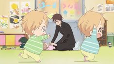 two anime characters are playing with a baby