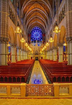 the inside of a church with pews and chandeliers on either side of the alter