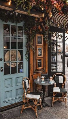 two chairs and a table in front of a building