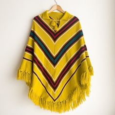 "This vintage knit poncho features a bold acid green, yellow, and chartreuse chevron print, perfect for making a statement.  The poncho has a loose, hippy style and is made from a soft knit material that provides a comfortable fit.  The size type is regular and fits women's M/L.  The decade of this piece is the 1970s and its country/region of manufacture is unknown.  This item falls under the categories of coats, jackets, and vests, as well as women's vintage clothing, vintage, specialty, and cl Oversized Hippie Poncho For Winter, Yellow Winter Festival Outerwear, Vintage Winter Poncho One Size, Vintage One-size Winter Poncho, One Size Vintage Poncho For Winter, Yellow Fall Poncho, Oversized Hippie Poncho For Fall, Oversized Long Sleeve Hippie Poncho, Green Bohemian Poncho For Fall