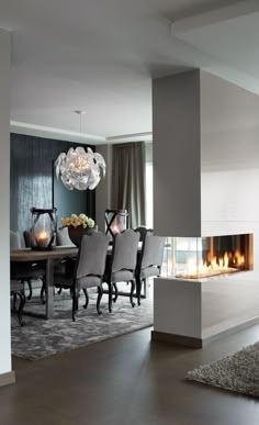 an elegant dining room with fireplace and chairs