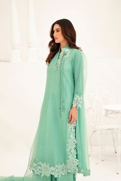 This light green Shalwar Kameez features a mint green organza lined shirt with lace appliqué all over the body and chaak, accompanied by a matching organza cutwork dupatta. The delicate lace adds an elegant touch to the traditional style, making this outfit perfect for any formal occasion. 3-Piece Suit Formal Green Salwar Kameez With Sheer Dupatta, Green Organza Sets For Formal Occasions, Green Georgette Sets For Formal Occasions, Green Georgette Formal Sets, Green Organza Dupatta For Formal Occasions, Formal Green Georgette Sets, Formal Green Lawn Suit With Dupatta, Green Organza Dress With Resham Embroidery, Formal Green Salwar Kameez With Resham Embroidery