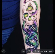 a person with a tattoo on their arm that has a skull and snake in it