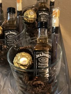 several bottles of jack daniels are in a glass bowl