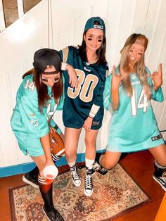 three girls in sports uniforms posing for the camera