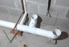 a white pipe laying on top of a cement floor