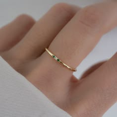 Minimalist style emerald ring is great for a dainty look and great for pairing with other rings!  - - - D E T A I L S - - - * Made of 925 Sterling Silver * Available in 14k Gold or Rhodium Plated * We use a THICK, DURABLE plating - for a piece that will last you years to come! * VERY HIGH QUALITY * Available in sizes 4-10 * Ring Width: 1.4mm * Features 3 small Cubic Zirconia Stones - made of the highest grade for an authentic diamond & emerald look! * Also available in Sapphire, Ruby and Diamond colored stones Diamond https://www.etsy.com/listing/654125758/dainty-ring-gold-minimalist-ring?click_key=d3db711020a80a7b87c274e916d1b52c5c1a78cb%3A654125758&click_sum=69d6f74b&ref=shop_home_active_7&pro=1&sts=1 Ruby https://www.etsy.com/listing/1382697466/ruby-ring-minimalist-ring-birthstone?click Small Emerald Ring, Simple Emerald Ring, 3 Stone Diamond Ring, Smaragd Ring, Dainty Gold Rings, Gold Mangalsutra, Zierlicher Ring, Mangalsutra Designs, 3 Stone Rings