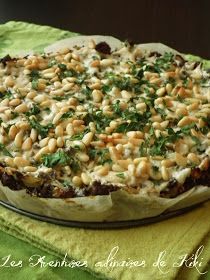 a pizza with lots of toppings sitting on top of a green cloth next to a wooden table