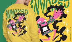 a man wearing a yellow shirt with pink and green cartoon characters on it's back