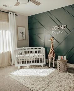 a baby's room with a giraffe statue in the corner and a white crib