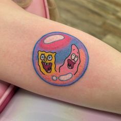 a person with a cartoon tattoo on their arm