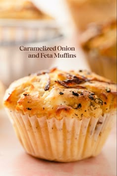 a close up of a muffin on a table with the title caramelized onion and feta muffins