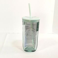 a glass cup with a straw in it